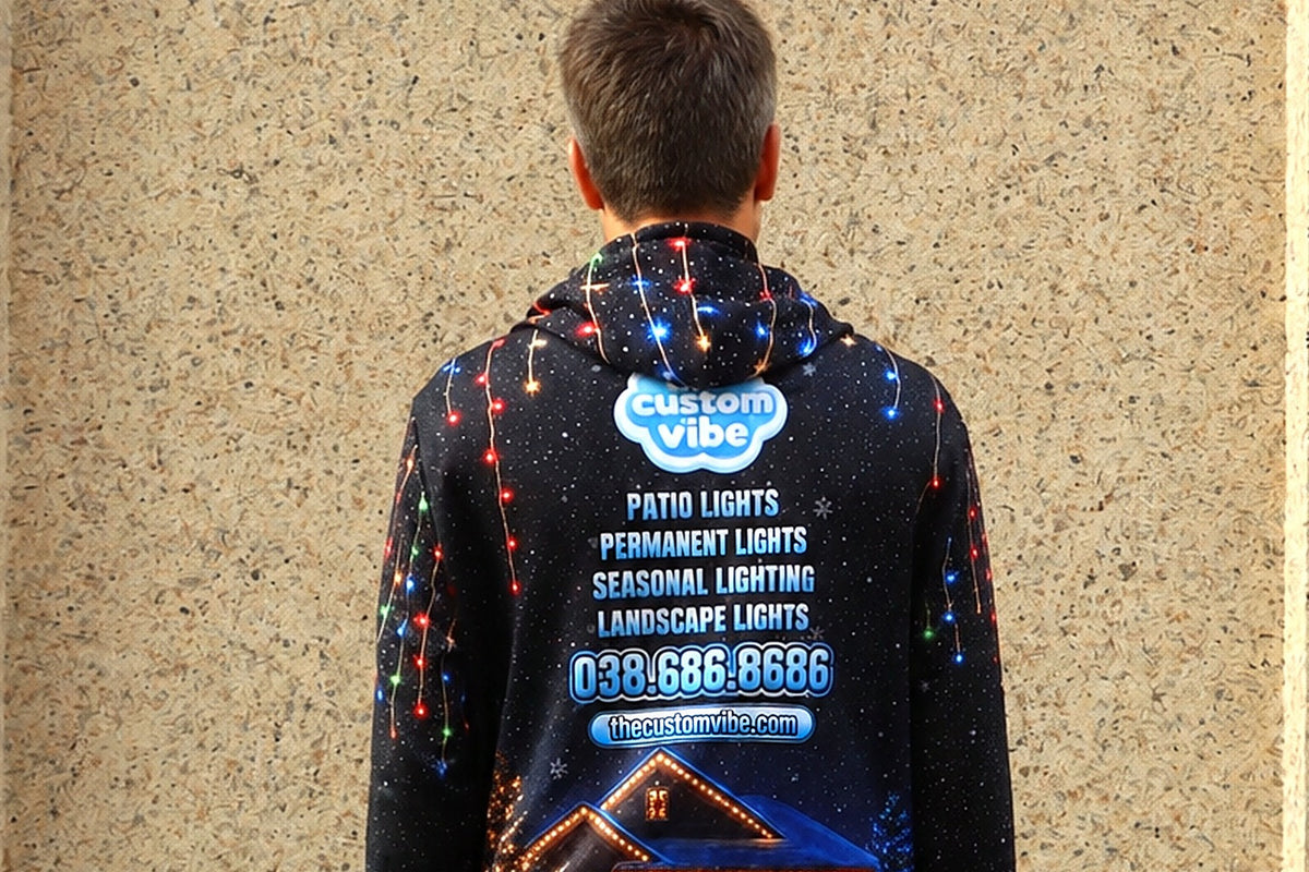 Model wearing a custom printed hoodie from behind with logo, services and phone number